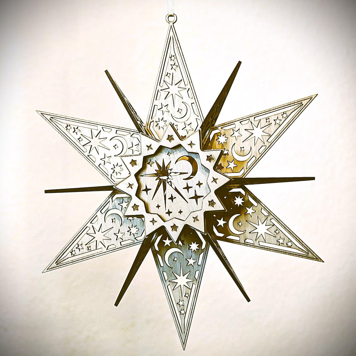 Decorative star with intricate cut-out patterns on a light background