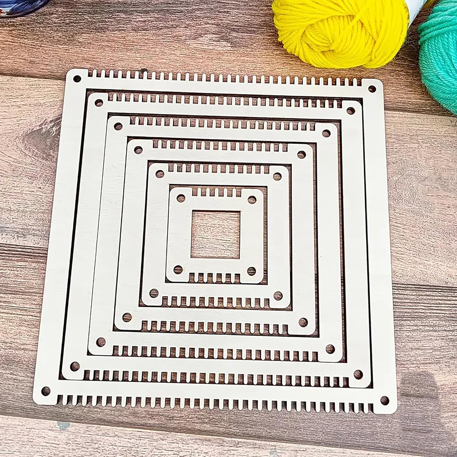 Metal knitting needle case with square patterns on a wooden surface 