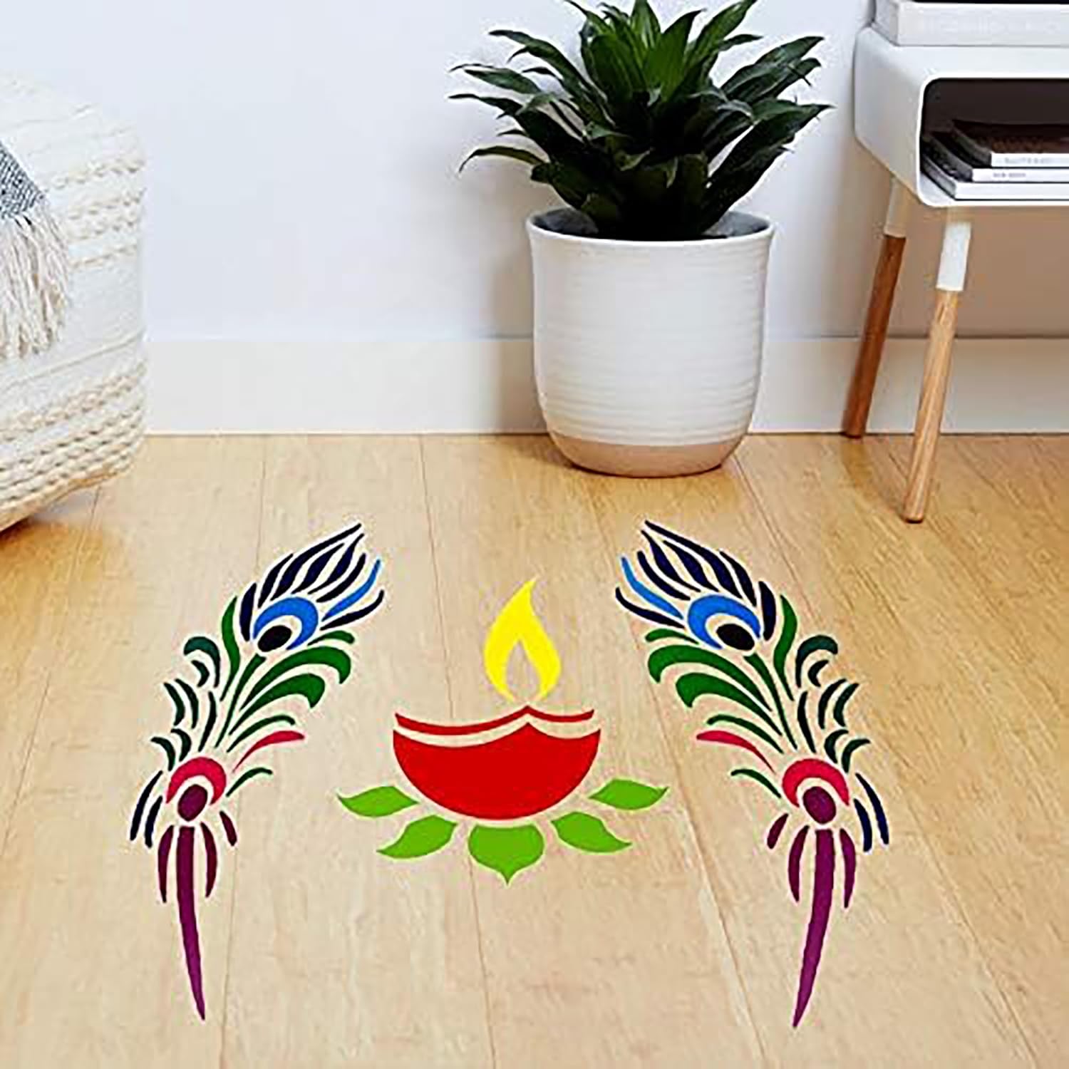 Decorative peacock feather and Diwali lamp stickers on a wooden floor.