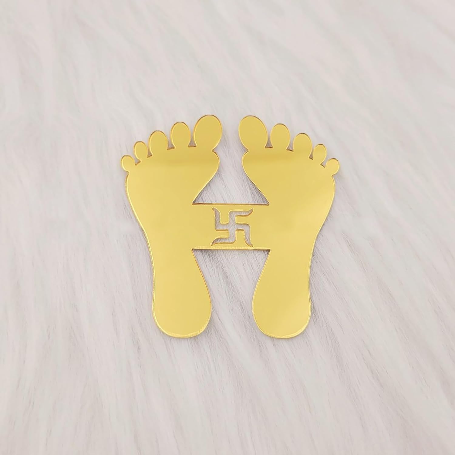 Gold footprints with a swastika symbol on a light gray background