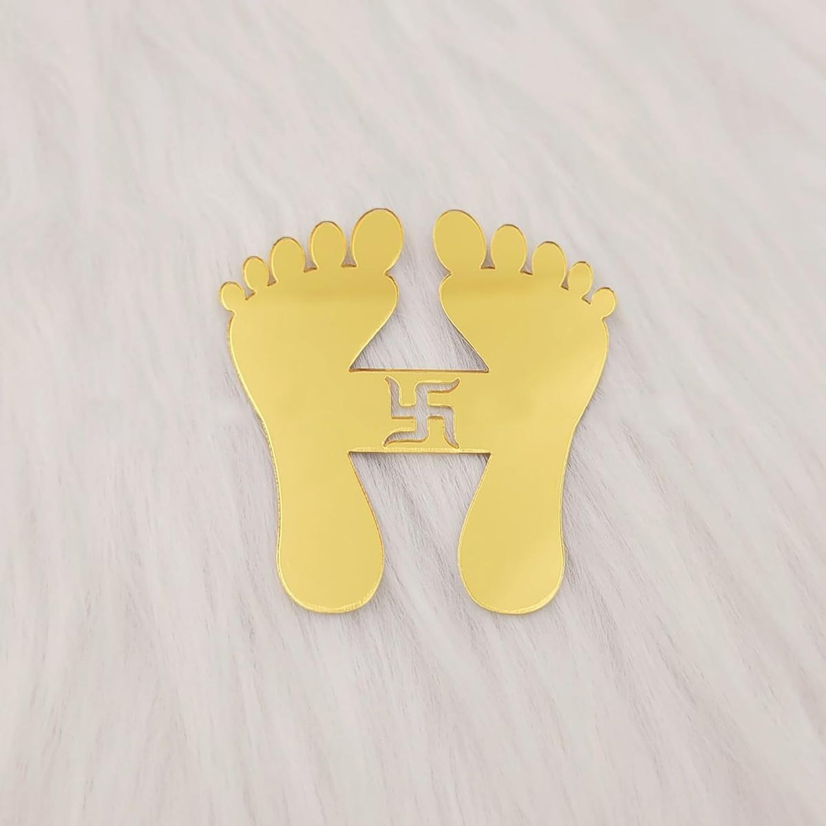 Gold footprints with a swastika symbol on a light gray background