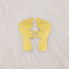 Gold footprints with a swastika symbol on a light gray background