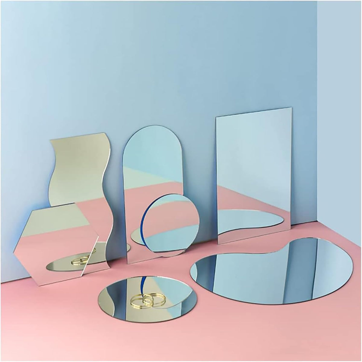 Set of geometric mirrors on a pink and blue gradient background
