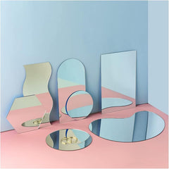 Set of geometric mirrors on a pink and blue gradient background