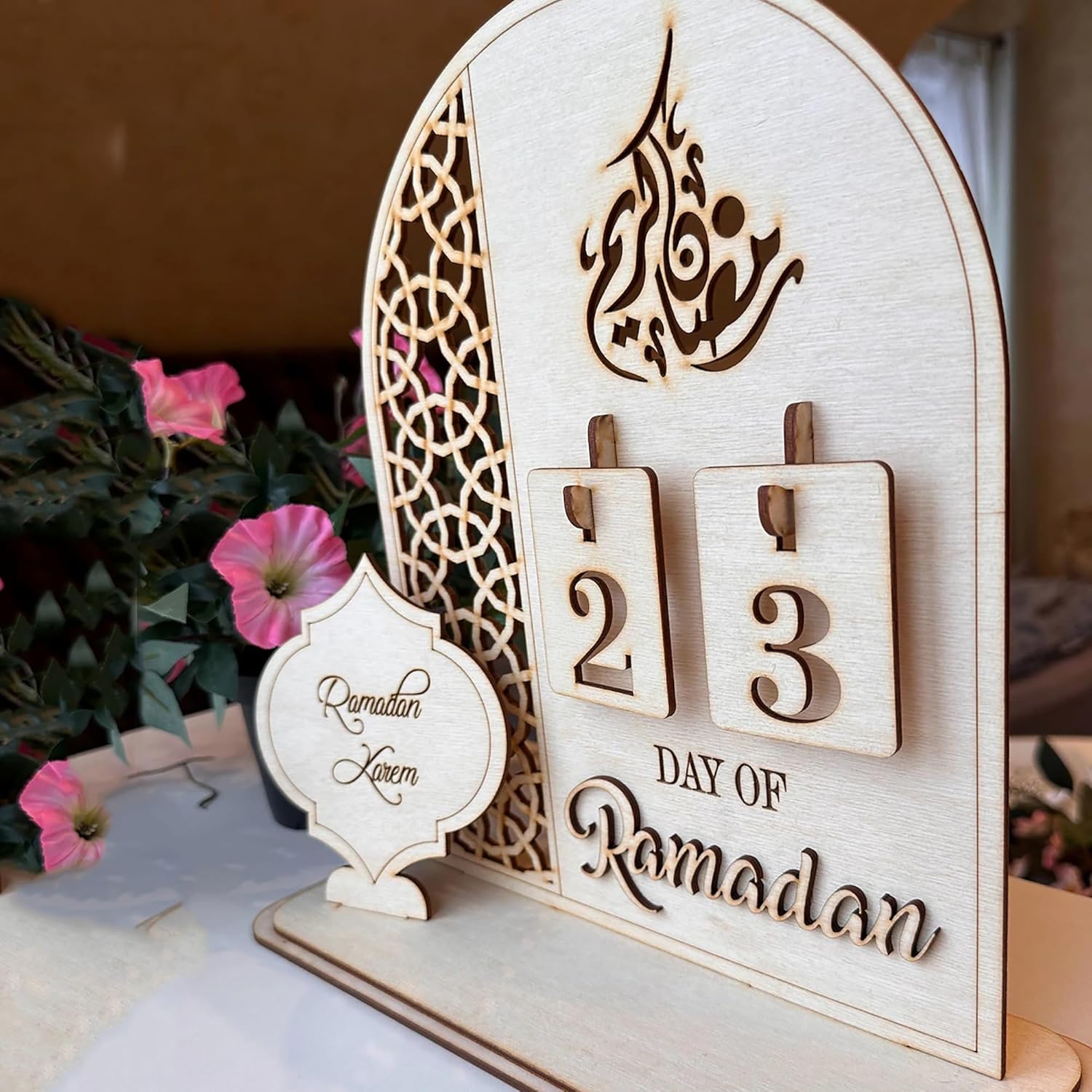 Wooden Ramadan calendar with decorative elements on a table.